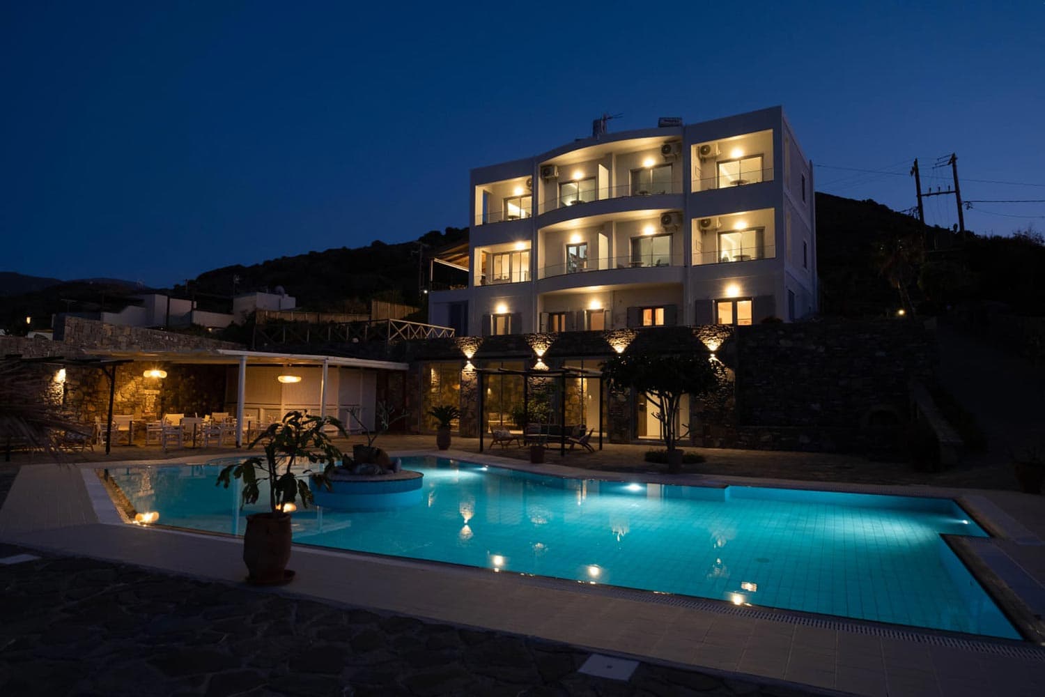 Mochlos Blue lit up at night, seen from the pool area