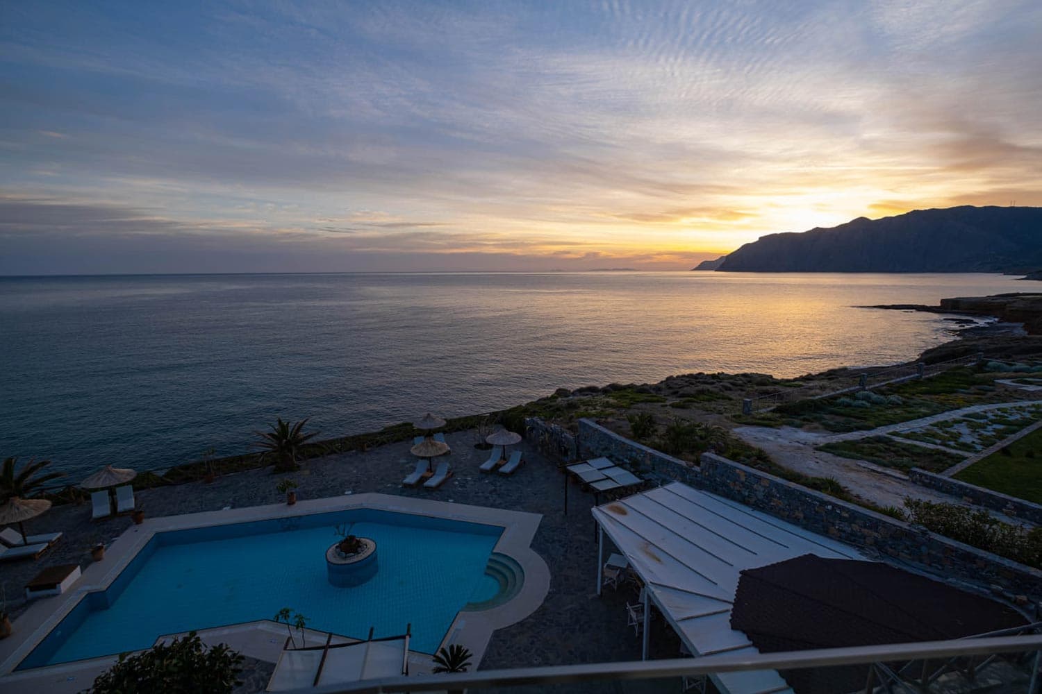 Mochlos Blue — room terraces overlooking the Aegean at dusk
