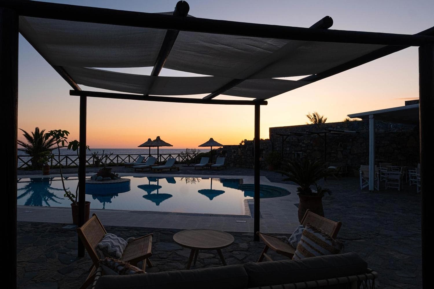 Poolside seating area at Mochlos Blue in the evening